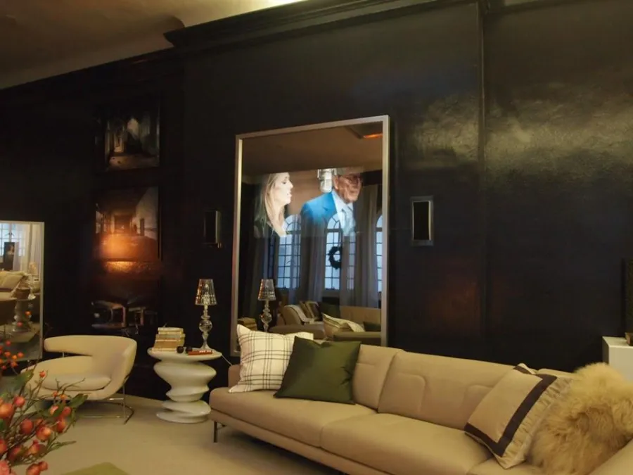 Television hidden behind a mirror in a dark lounge