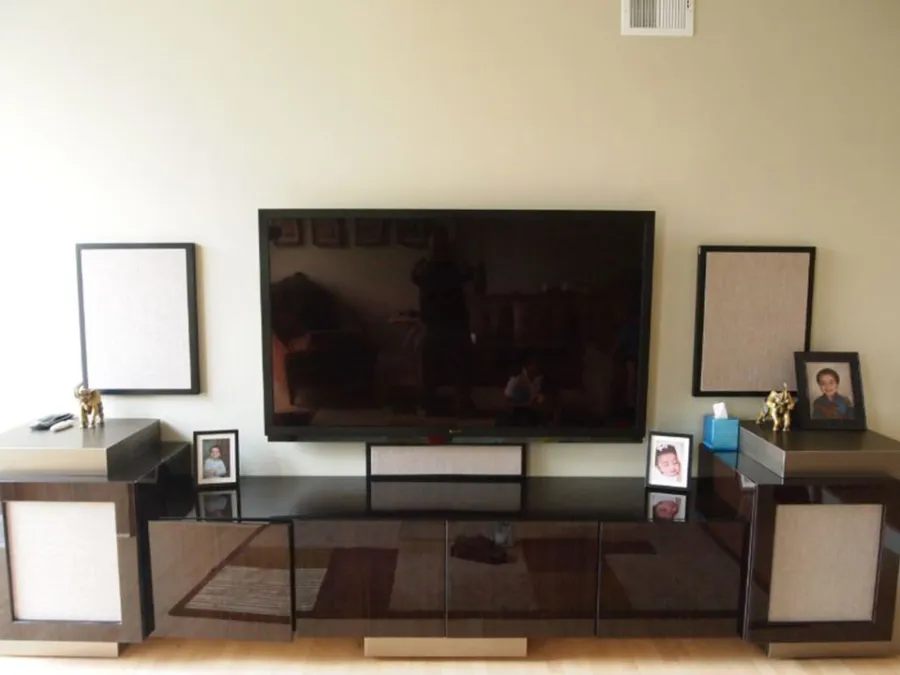 Custom media console with hidden fabric-covered speakers